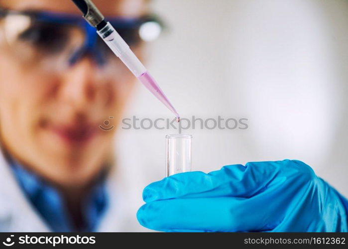 Laboratory technician with micro pipette