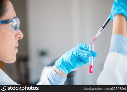 Laboratory technician with micro pipette