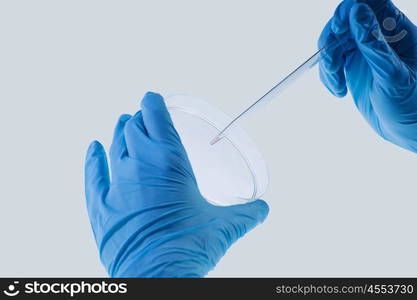 Laboratory test. Close up image of scientist hands holding droplet