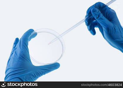 Laboratory test. Close up image of scientist hands holding droplet