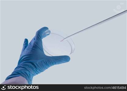 Laboratory test. Close up image of scientist hands holding droplet
