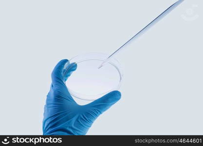 Laboratory test. Close up image of scientist hands holding droplet