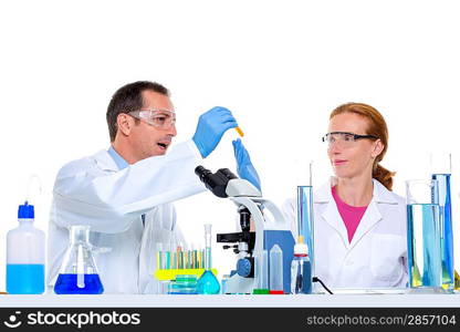 laboratory with two scientist working with test tubes flask and microscope