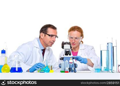 laboratory with two scientist working with test tubes flask and microscope