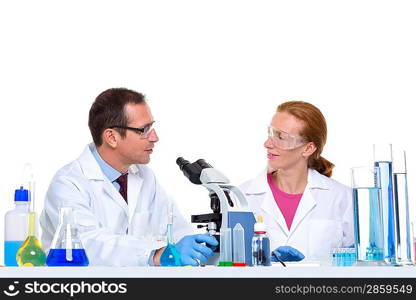 laboratory with two scientist working with test tubes flask and microscope