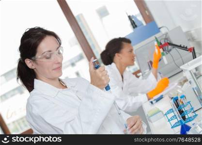 Laboratory worker using pipette