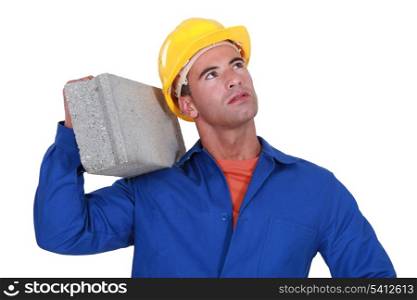 Laborer carrying cinderblock