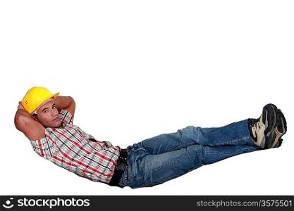 Laborer doing sit ups, isolated on white background