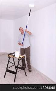 Laborer painting ceiling