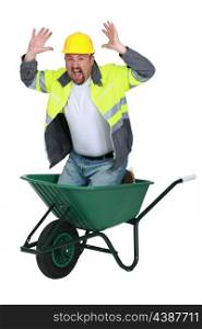 Laborer sitting in a wheelbarrow screaming