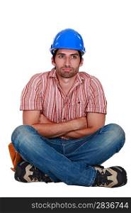 Laborer sitting with arms crossed