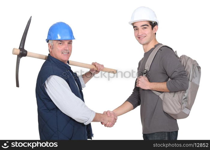 Laborer welcoming young apprentice