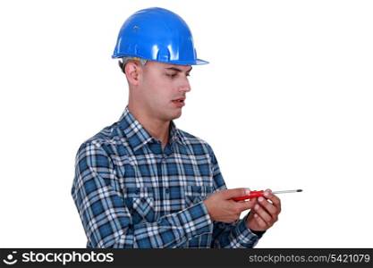 Laborer with screwdriver, studio shot