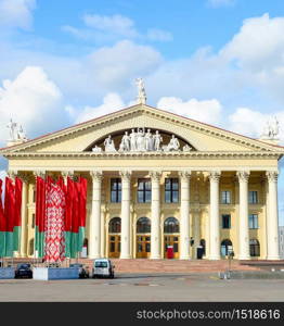 Labour Union Palace of Culture, waving national flags at central October Square, Minsk, Belarus