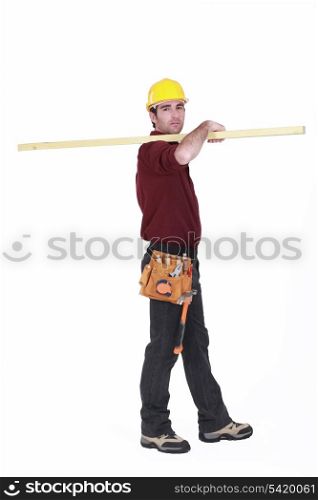 Labourer carrying a plank