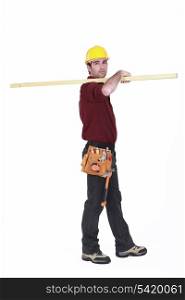 Labourer carrying a plank