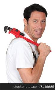 Labourer holding tool over shoulder