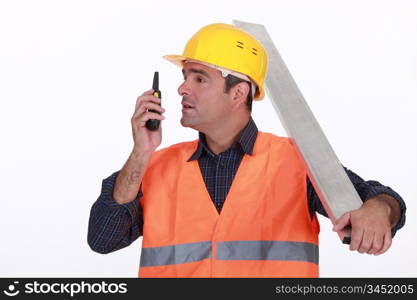 Labourer speaking into a walkie-talkie