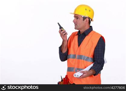 Labourer speaking into a walkie-talkie