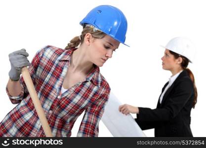 Labourer working beside an engineer