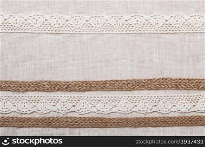 Lace frame on natural linen, bright cloth fabric background. Retro style