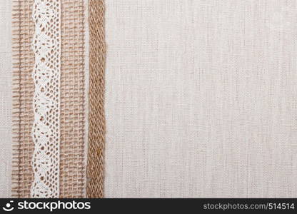 Lace frame on natural linen, bright cloth fabric background. Retro style