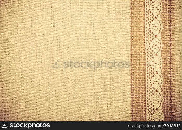 Lace frame on natural linen, bright cloth fabric background. Retro vintage style