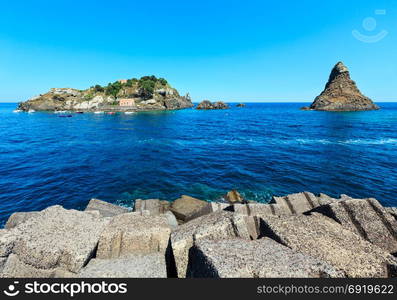 Lachea Island on Cyclopean Coast and the Islands of the Cyclops on Aci Trezza town (Italy, Sicily,10 km north of Catania). Known as Isoles Dei Ciclopi Faraglioni. People unrecognizable.