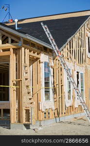 Ladder against wooden house construction