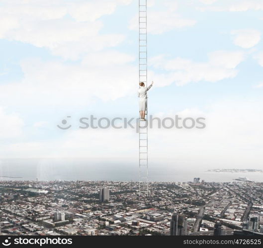 Ladder of success. Businesswoman standing on ladder high above city