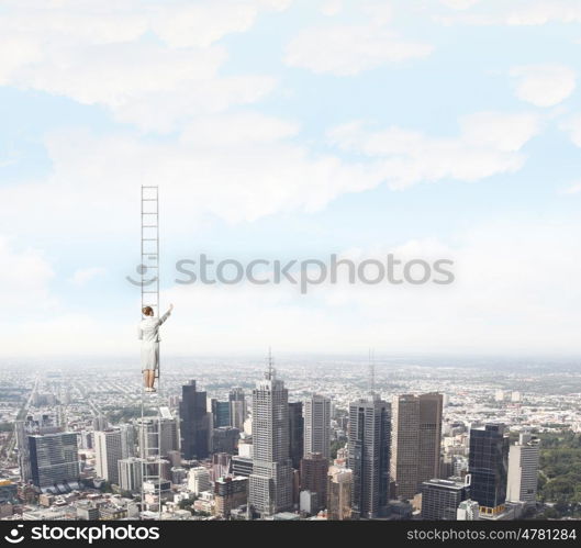 Ladder of success. Businesswoman standing on ladder high above city