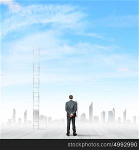 Ladder of success. Rear view of businessman standing near ladder going high in sky