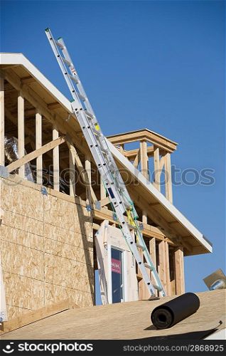 Ladder on wooden house construction