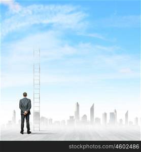 Ladder to top. Back view of businessman standing near long ladder to sky