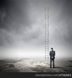 Ladder to top. Back view of businessman standing near long ladder to sky