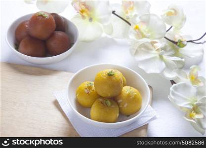 Laddu and gulab jamun in a bowl