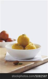 Laddu and gulab jamun in a bowl