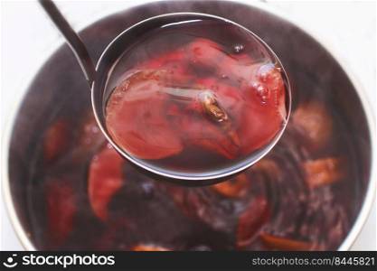 ladle with compote over a pan