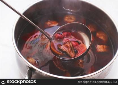 ladle with compote over a pan