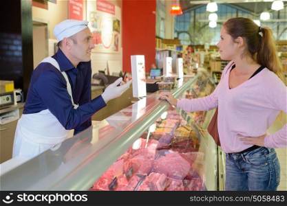 Lady at meat counter
