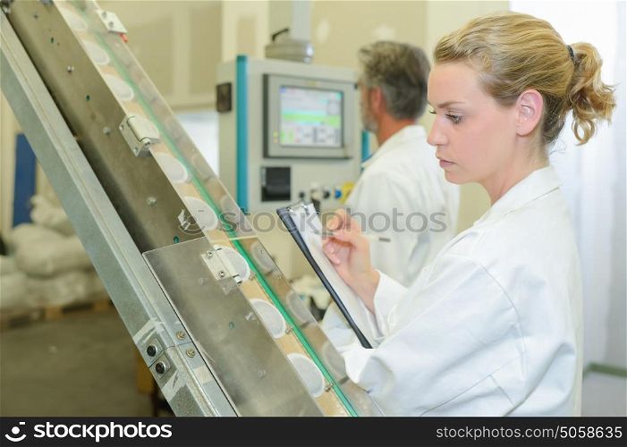 Lady auditing in factory