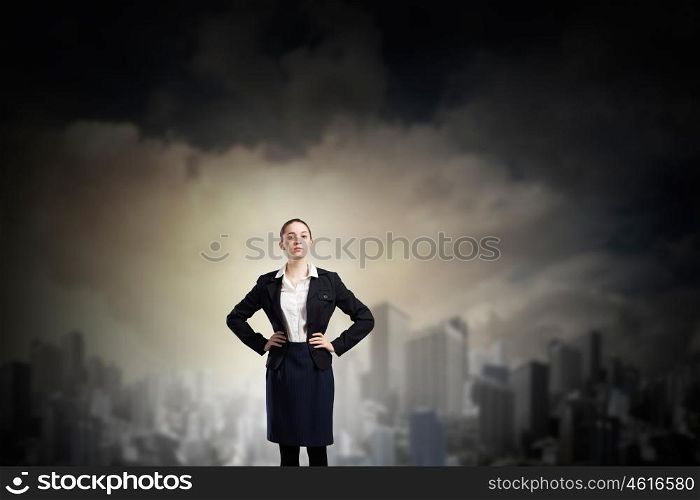 Lady boss. Young confident businesswoman with hand on waist