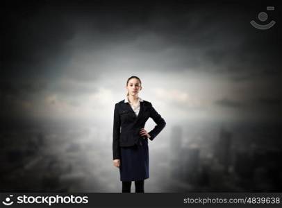 Lady boss. Young confident businesswoman with hand on waist