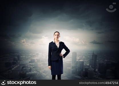 Lady boss. Young confident businesswoman with hand on waist