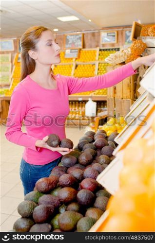 Lady buying avocados