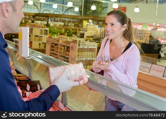 Lady buying joint of meat