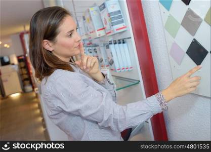 Lady choosing colour of wall tiles