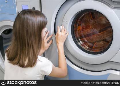 lady closing washing machine door