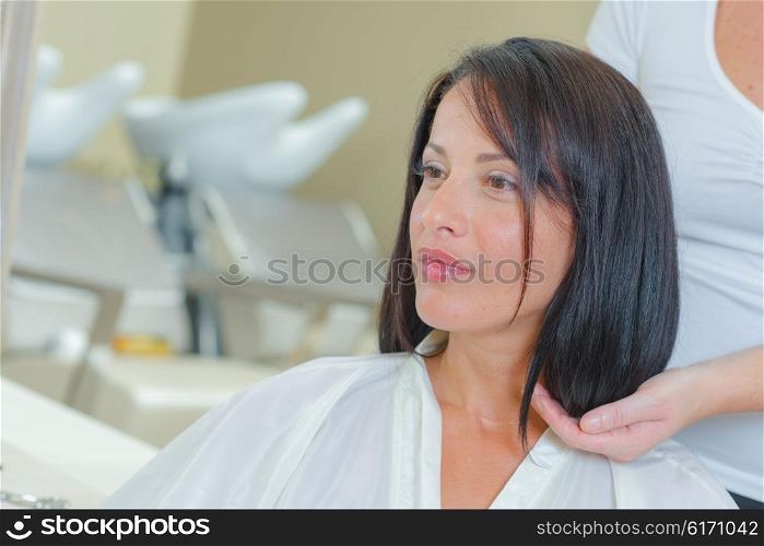 Lady contemplating length for haircut