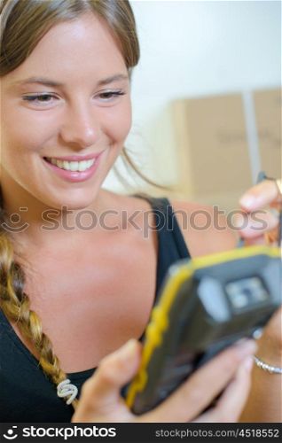 Lady electronically signing to receive a parcel